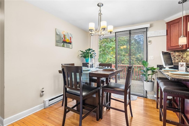 dining room featuring a notable chandelier, a baseboard radiator, and light hardwood / wood-style flooring