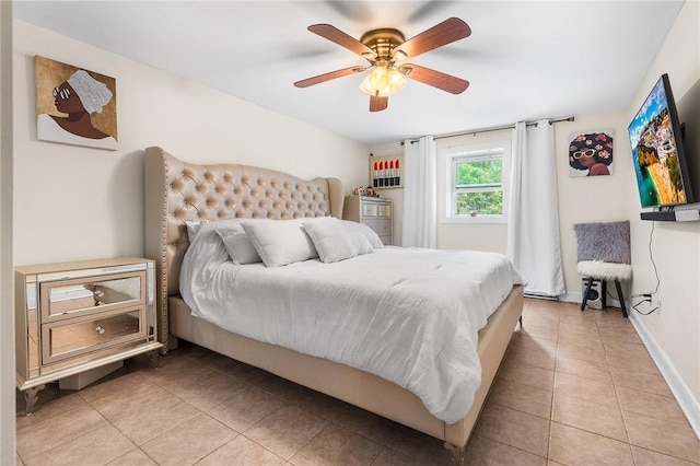 tiled bedroom featuring ceiling fan