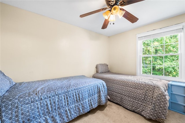 bedroom featuring light carpet and ceiling fan