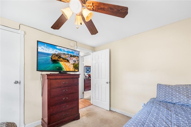 bedroom featuring ceiling fan and light carpet