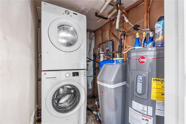 laundry room with electric water heater and stacked washer and clothes dryer