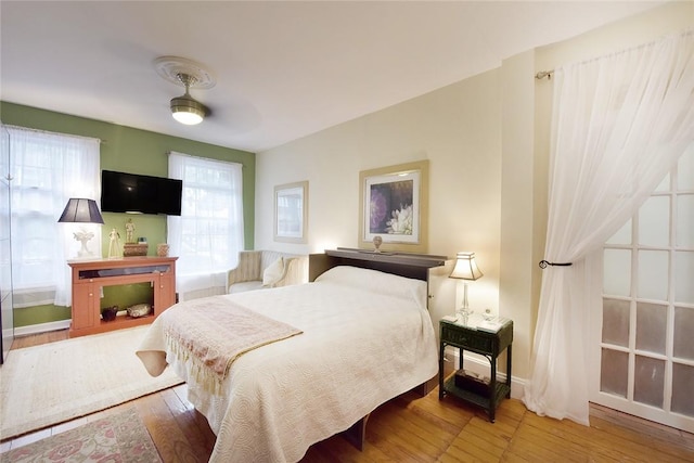 bedroom with ceiling fan and hardwood / wood-style flooring