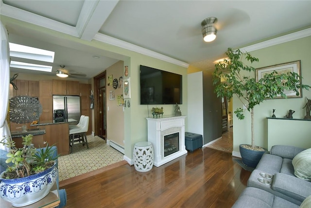 living room with ceiling fan, dark wood-type flooring, crown molding, a baseboard heating unit, and beamed ceiling