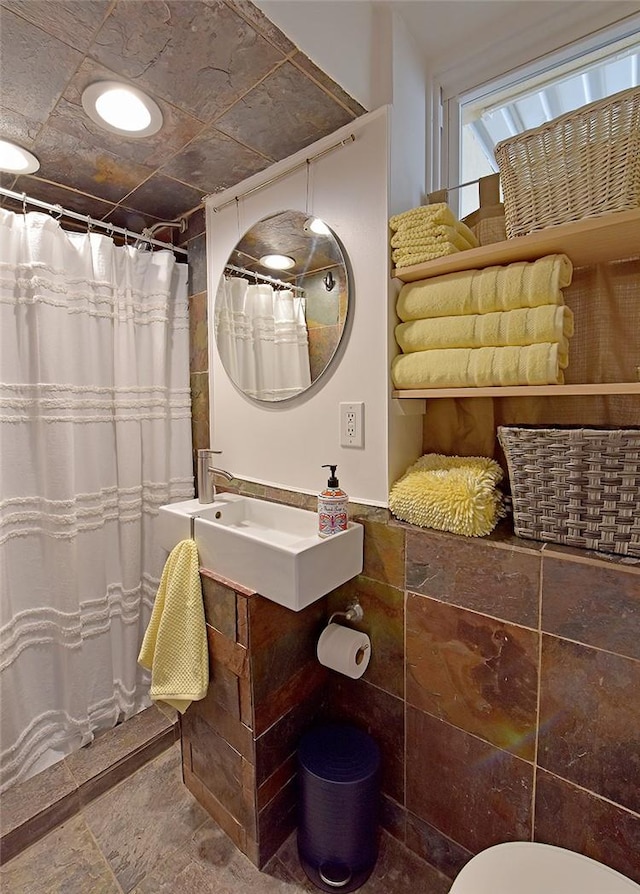 bathroom with curtained shower and toilet