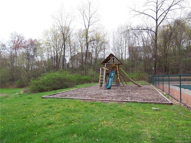 view of jungle gym featuring a lawn