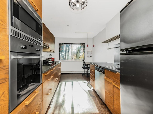 kitchen featuring black appliances and hardwood / wood-style floors