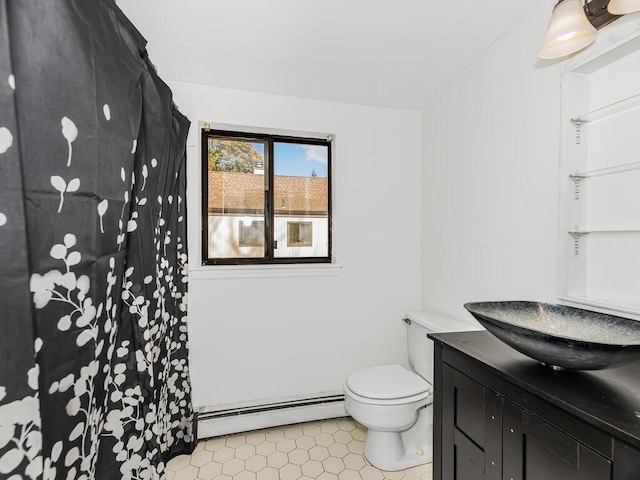 bathroom featuring tile patterned floors, vanity, toilet, and a baseboard heating unit