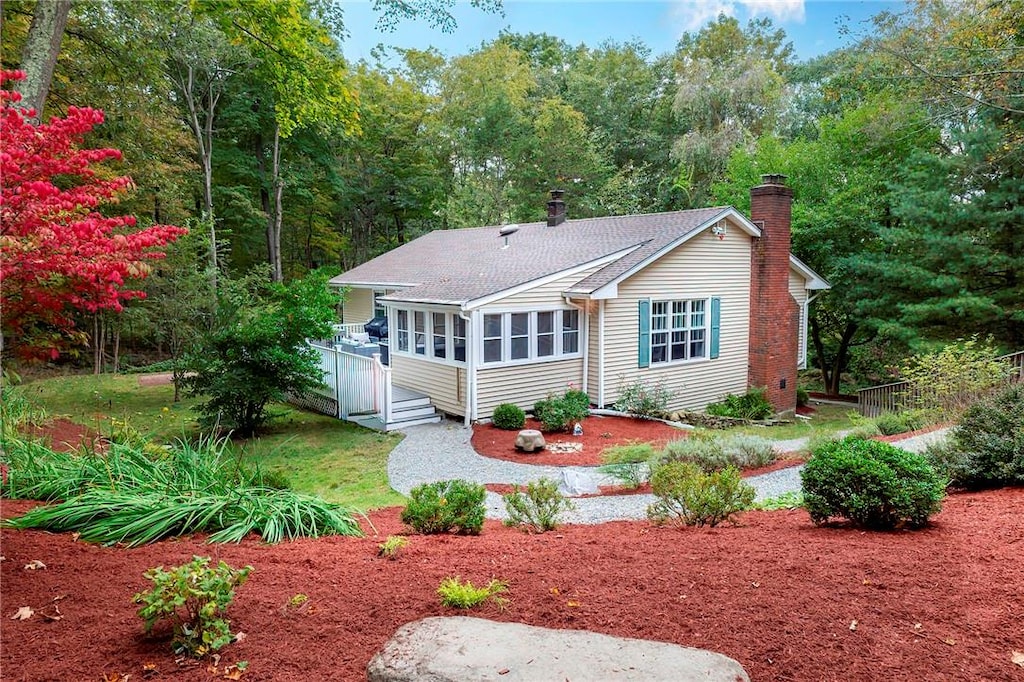 back of house with a sunroom