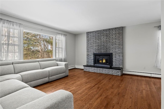 living room with a fireplace, a baseboard radiator, and hardwood / wood-style flooring