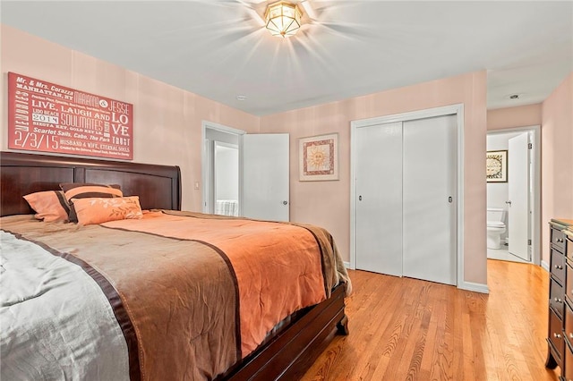 bedroom featuring ensuite bath, a closet, and light wood-type flooring