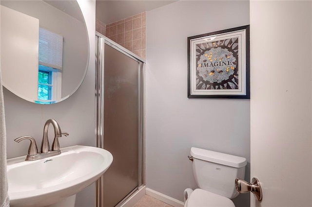 bathroom featuring sink, an enclosed shower, and toilet