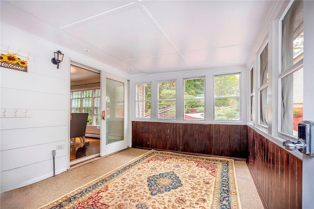 sunroom / solarium with plenty of natural light and a baseboard heating unit