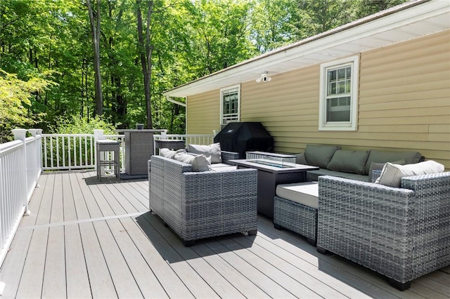 deck with area for grilling and an outdoor living space