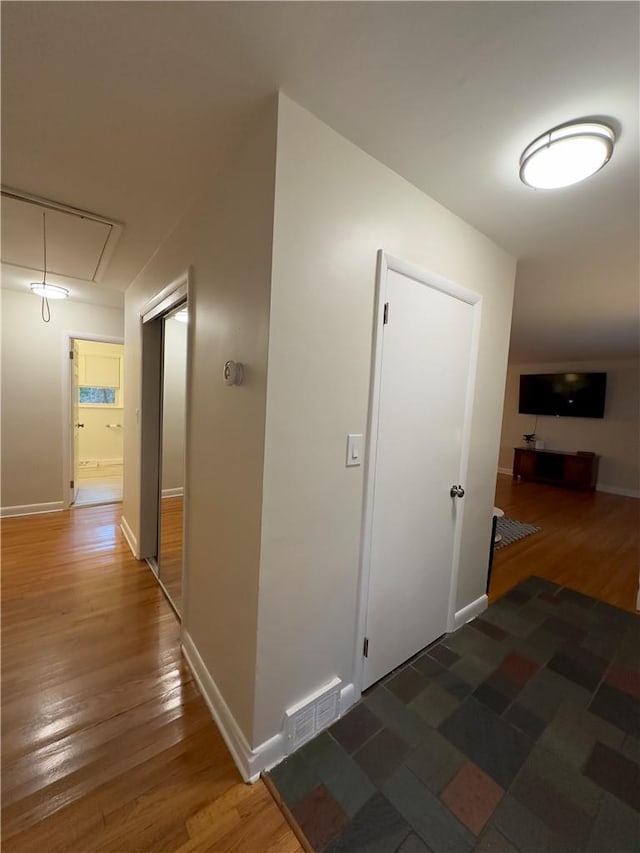 hallway with dark wood-type flooring