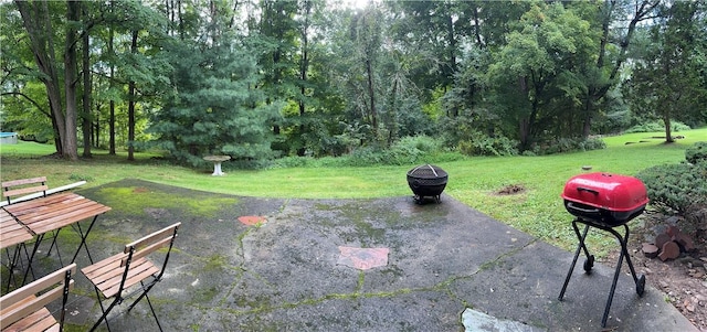 view of patio featuring grilling area and a fire pit