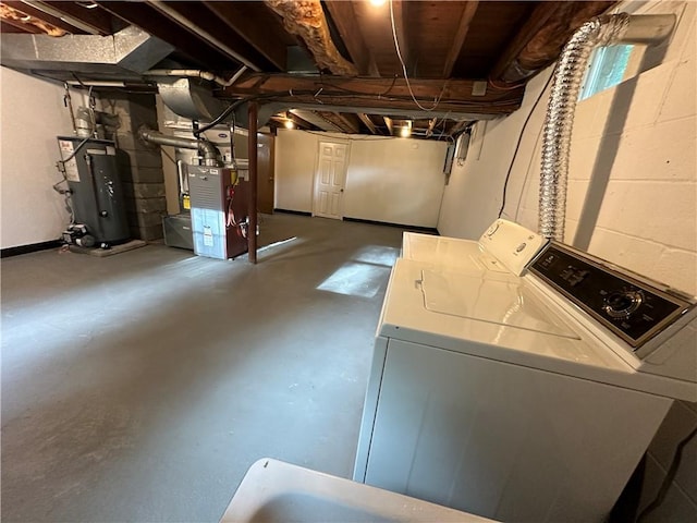 basement featuring washer and dryer and water heater