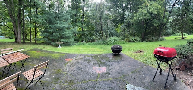 view of patio with a fire pit and a grill