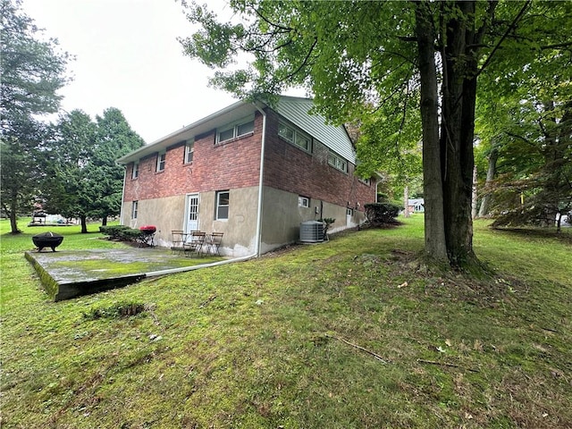 view of home's exterior featuring a yard and central AC