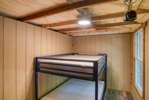 unfurnished bedroom featuring beam ceiling and wooden walls