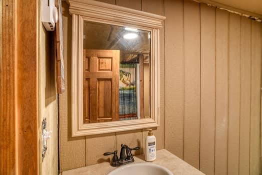 bathroom featuring sink and wooden walls