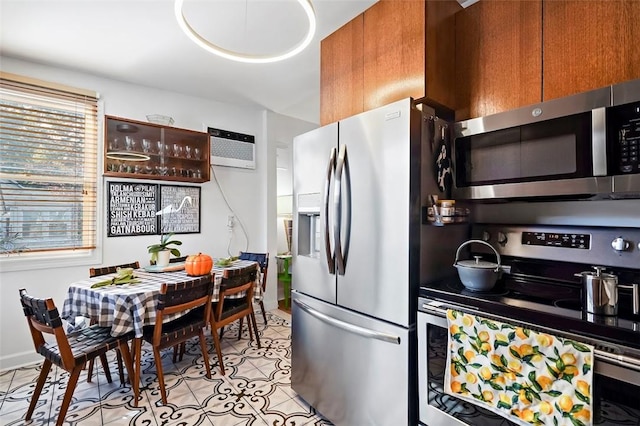 kitchen featuring appliances with stainless steel finishes, light tile patterned floors, and a wall mounted AC