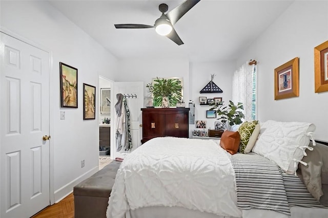 bedroom with parquet flooring, ensuite bath, and ceiling fan