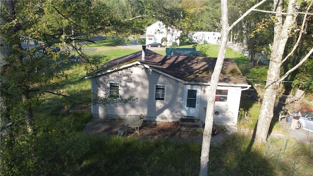 rear view of house with a yard