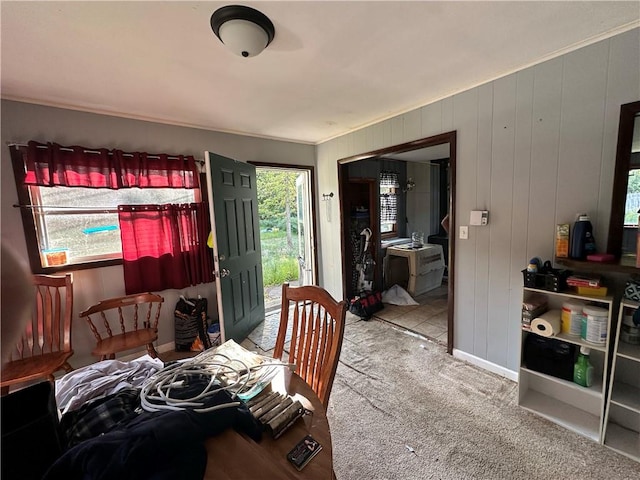 carpeted dining area with a healthy amount of sunlight and crown molding