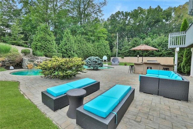 view of patio with an outdoor living space, an outdoor bar, and exterior kitchen