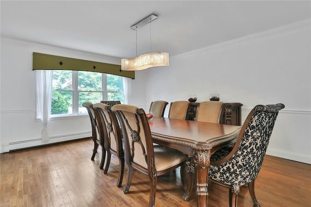 dining area featuring hardwood / wood-style floors, a baseboard radiator, and crown molding