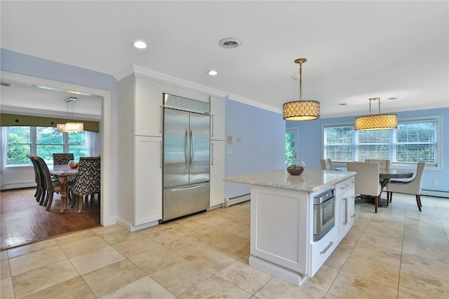 kitchen with white cabinetry, decorative light fixtures, and appliances with stainless steel finishes