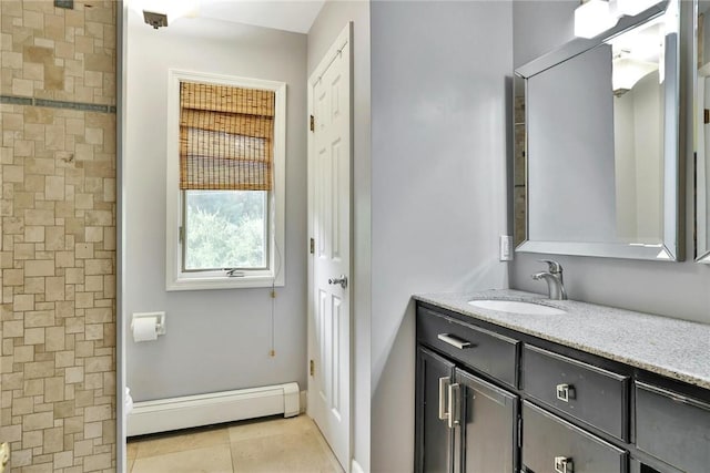 bathroom with vanity, tile patterned floors, and baseboard heating