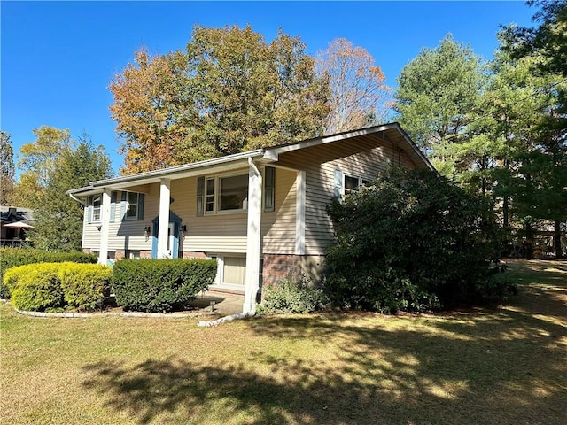 view of home's exterior featuring a lawn and a porch