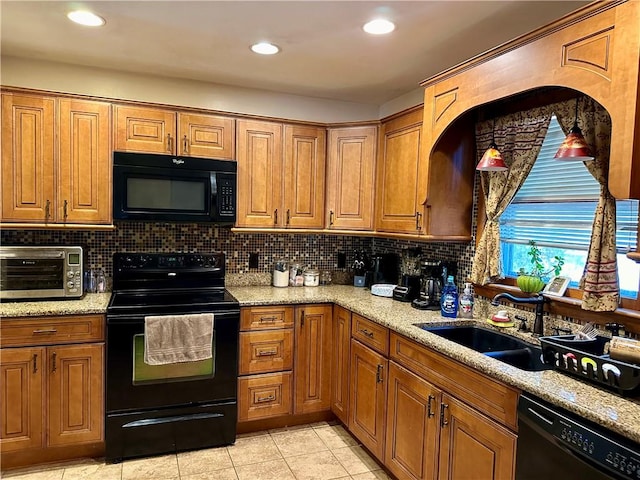 kitchen featuring black appliances, sink, light stone countertops, tasteful backsplash, and light tile patterned flooring