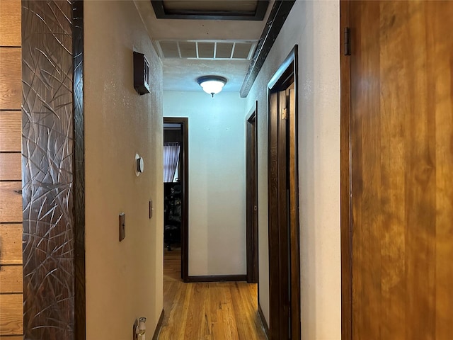 corridor with light hardwood / wood-style flooring