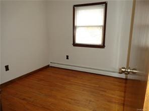 spare room featuring hardwood / wood-style floors