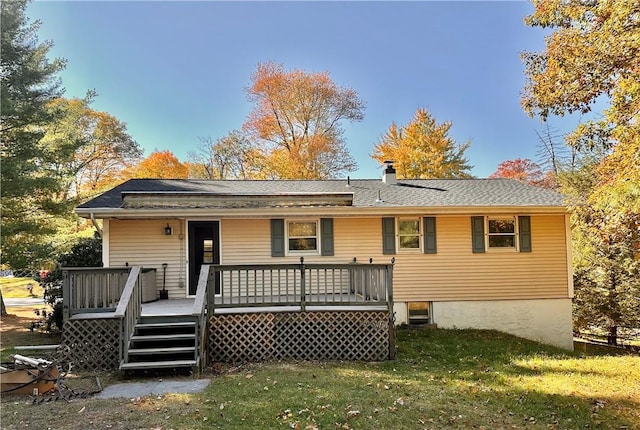 back of property featuring a yard and a wooden deck