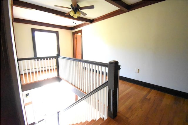 hallway with beam ceiling, wood-type flooring, baseboard heating, and ornamental molding