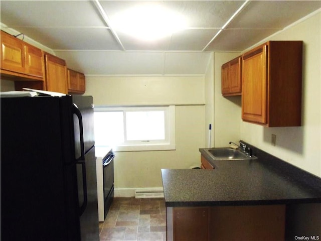 kitchen featuring black appliances, baseboard heating, and sink