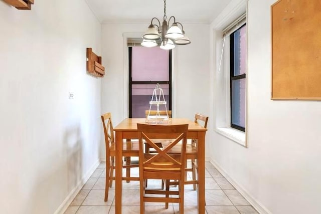 dining room with a chandelier, crown molding, and light tile patterned flooring