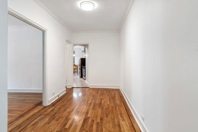 hallway with crown molding and hardwood / wood-style flooring