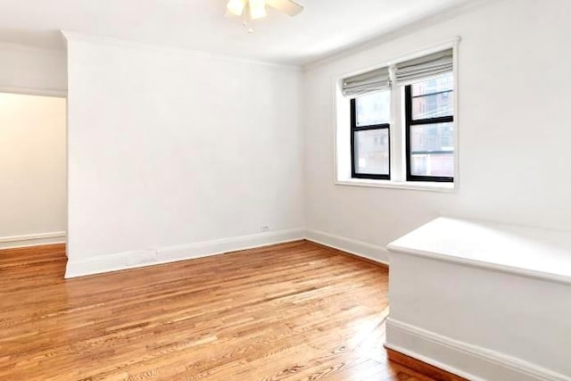 empty room with light hardwood / wood-style flooring, ceiling fan, and ornamental molding