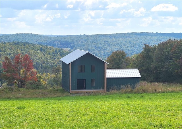 exterior space with a mountain view and a yard