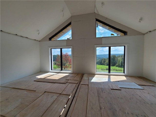 empty room featuring high vaulted ceiling