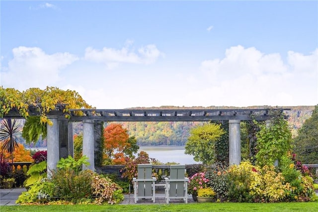 exterior space with a water view and a lawn