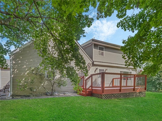 rear view of house with a deck and a lawn