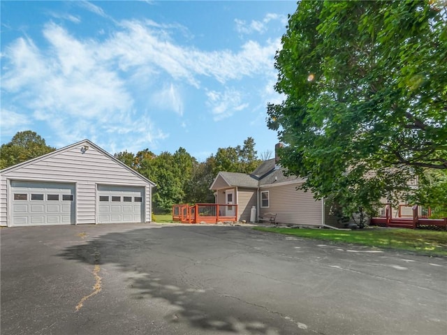 exterior space with a garage and a wooden deck