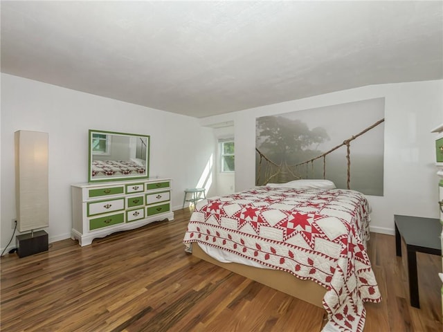 bedroom with dark wood-type flooring