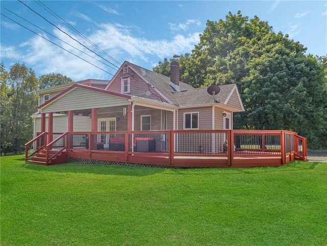 back of property with a lawn and a wooden deck