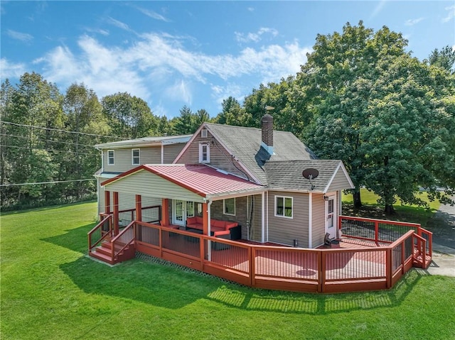 back of property featuring a lawn and a wooden deck